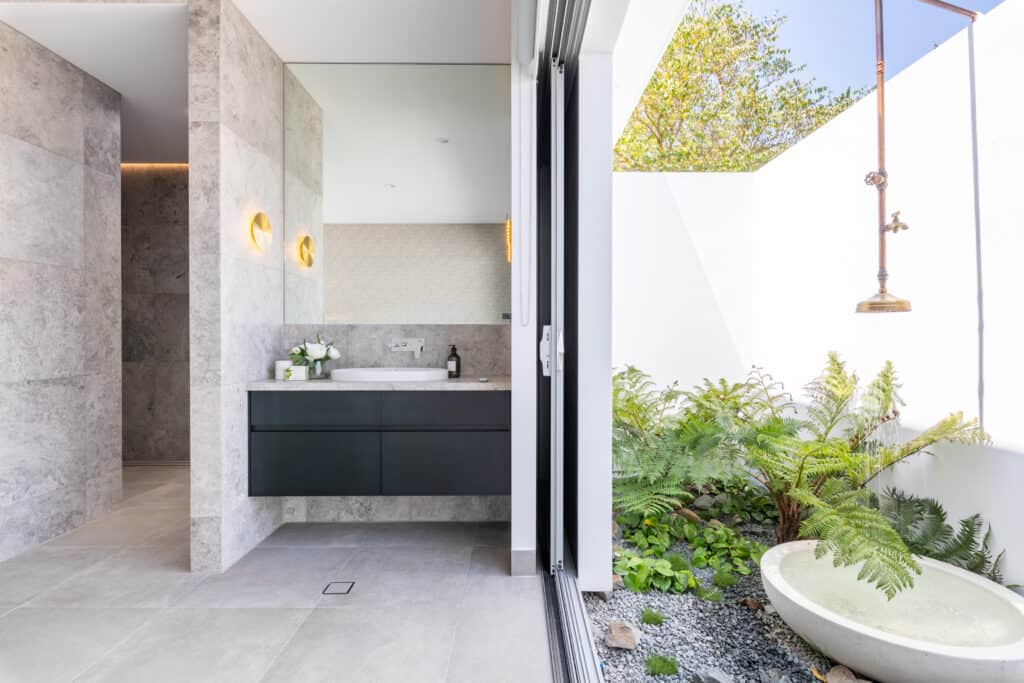 Modern bathroom open to the outside with an outdoor bath and shower