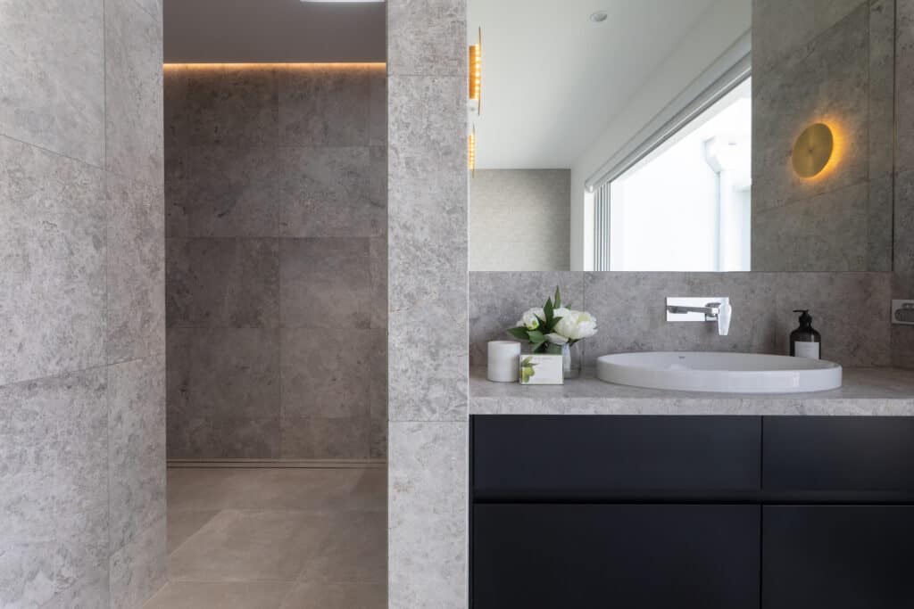 Modern bathroom with large wall mirror and white sink