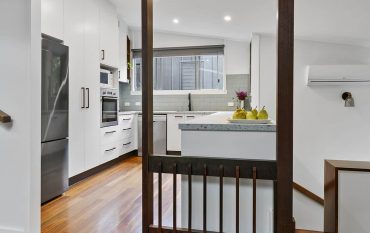 Kitchen renovation after photo of a modern white kitchen