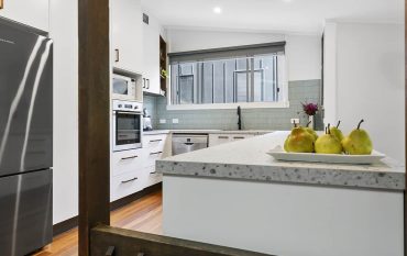 After photo of a modern white kitchen